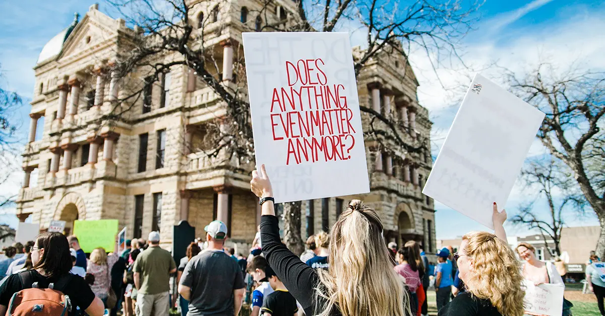 Carrying a big banner during a protest